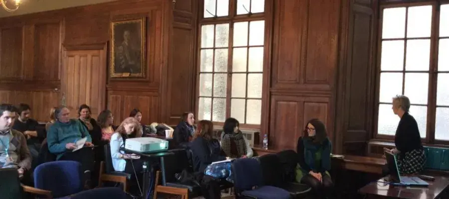Students sitting in a lecture theatre with big windows